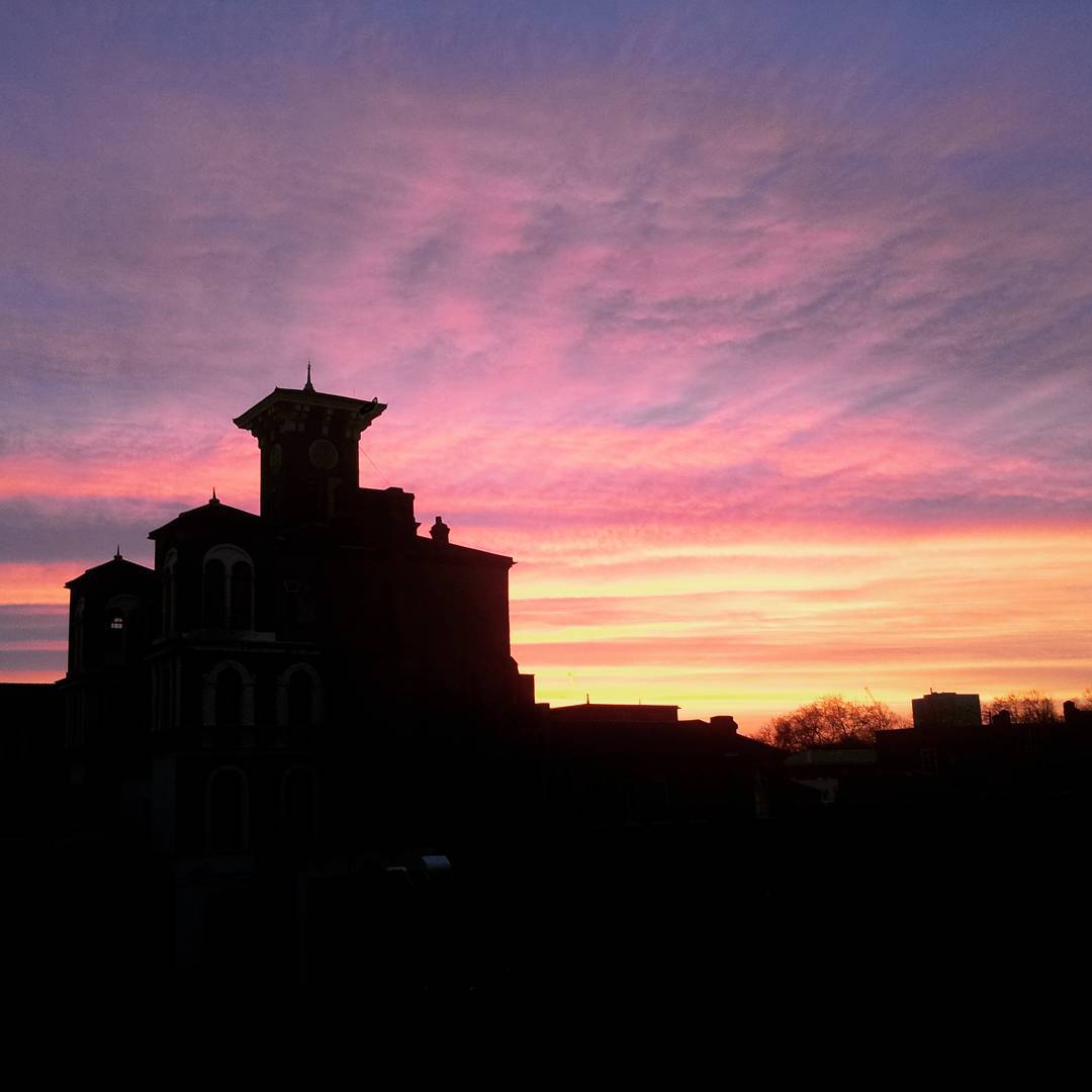 a sunset silhouette of an abandonded clock tower
