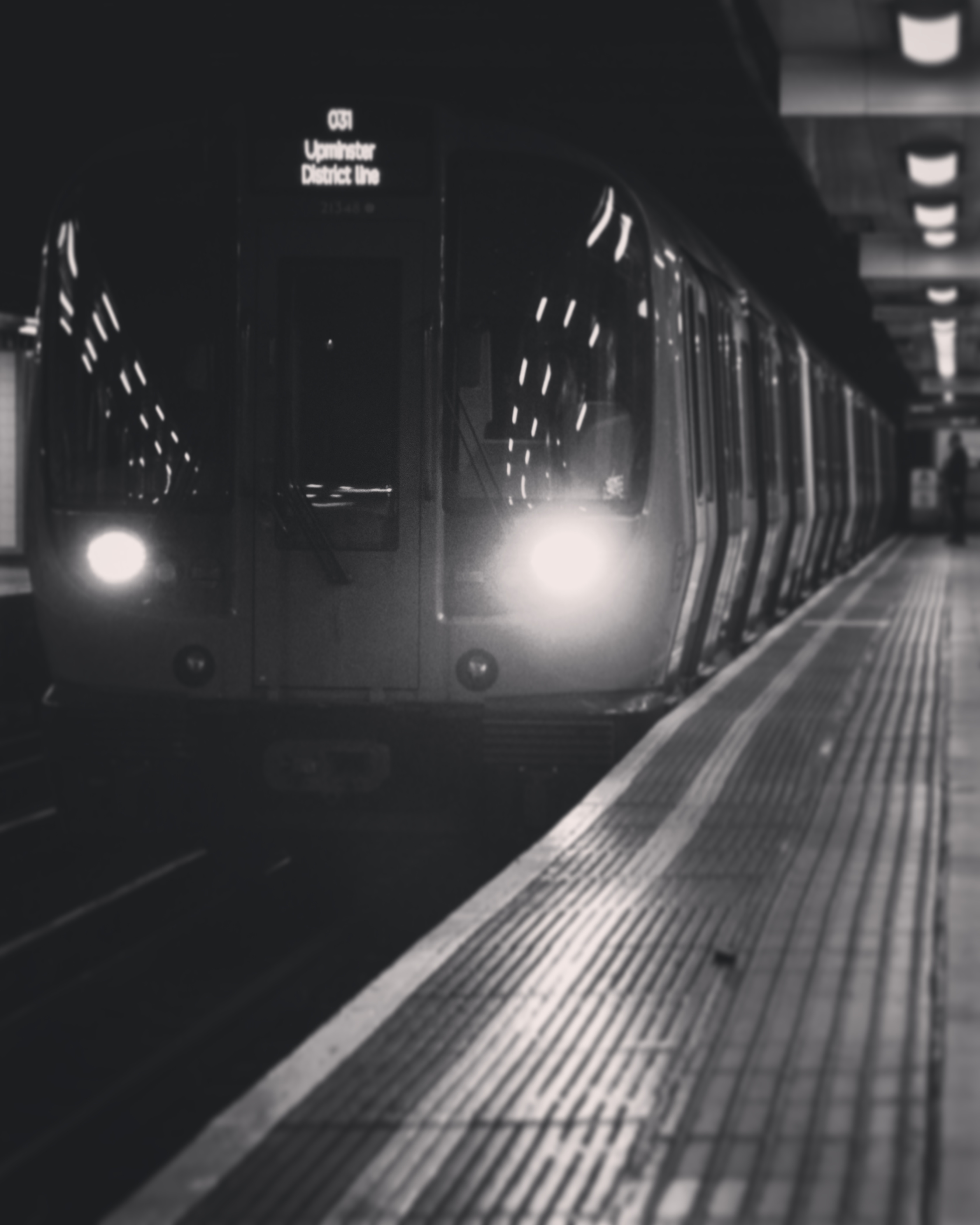a district line train approaching the station